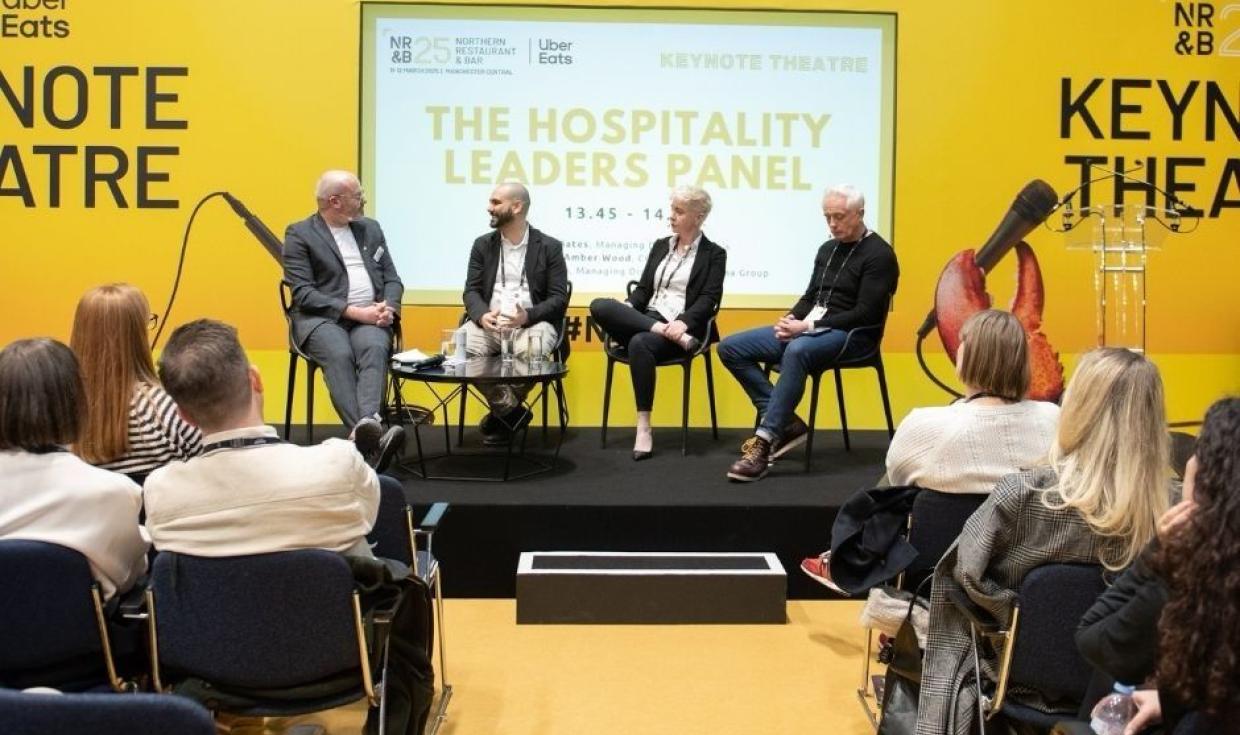 Four individuals sat on stage at the yellow NRB Keynote Theatre