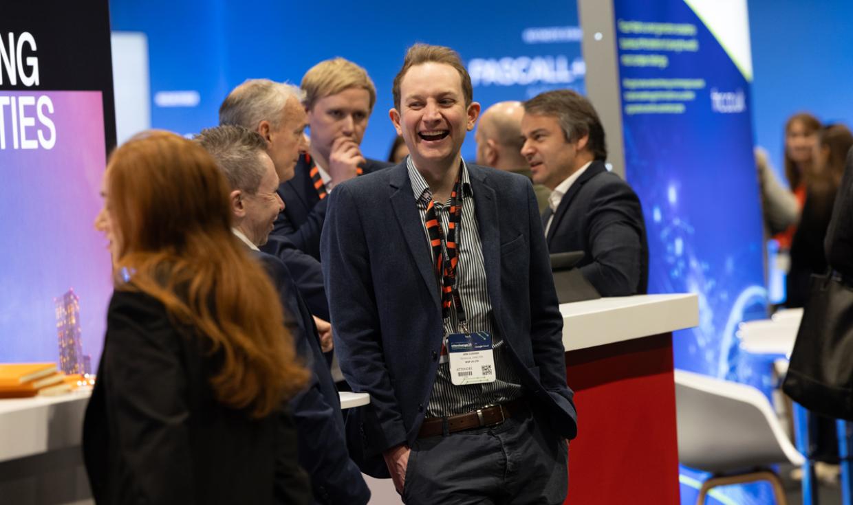 Individuals laughing at Interchange event.