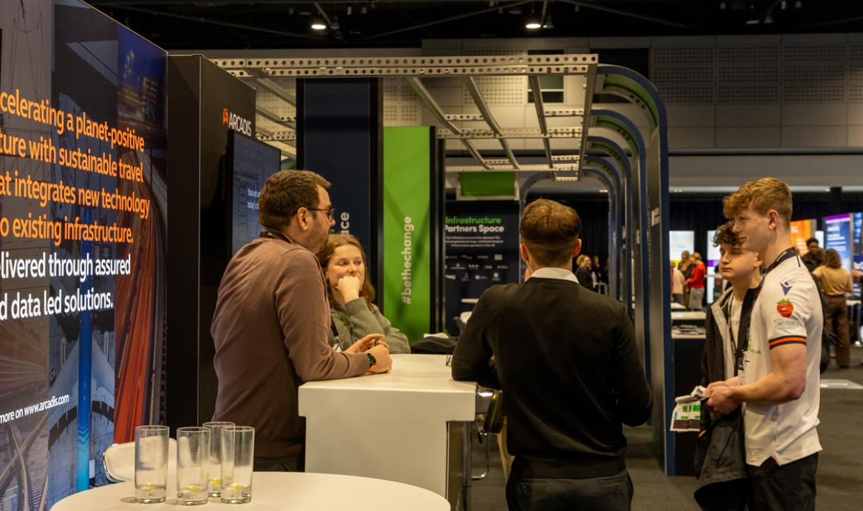 Delegates talking to exhibitors at exhibition stand at Interchange event.